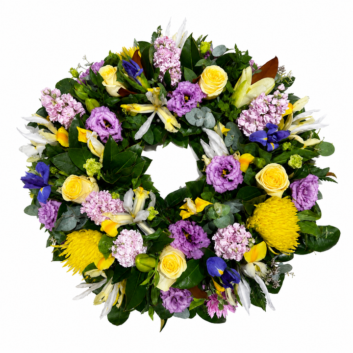  Lavender &amp; Gold Celebration Wreath, featuring elegant iris, yellow roses, purple lisianthus and fresh seasonal flowers. 