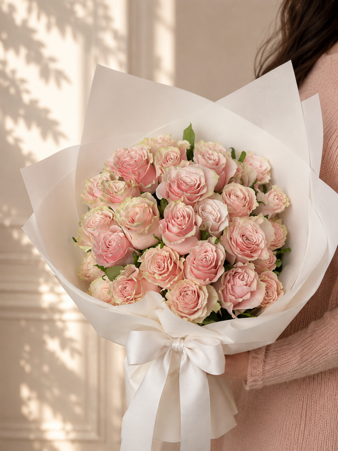Pink Promise bouquet featuring 36 premium pink roses elegantly wrapped in white paper with a satin ribbon. Perfect for anniversaries, birthdays and romantic occasions.