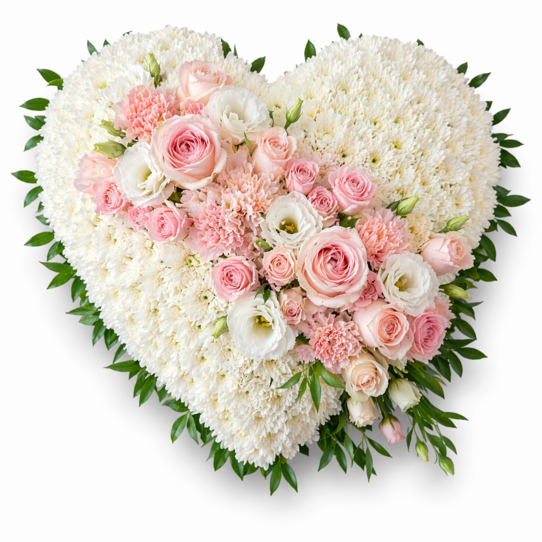 Heart-shaped arrangement of white and pink flowers on a white background