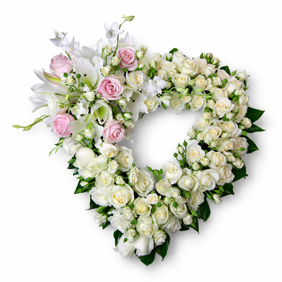 Heart-shaped flower arrangement with white and pink roses on a white background