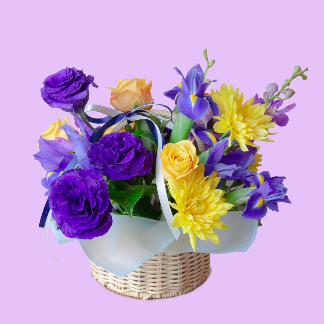 Golden Lavender Basket
Purple & Yellow Flower Basket
A vibrant flower basket featuring elegant purple blooms, golden yellow roses and chrysanthemums, beautifully arranged with fresh seasonal flowers to celebrate life's special moments with warmth, joy and elegance.