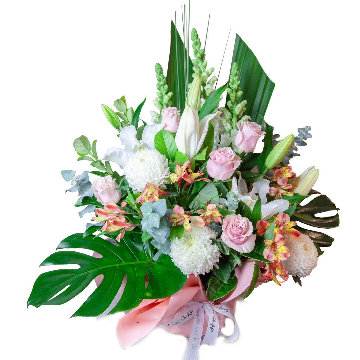 Blush Tropicana Garden featuring blush pink roses, white lilies, seasonal flowers and lush tropical foliage arranged in a modern garden-style design.