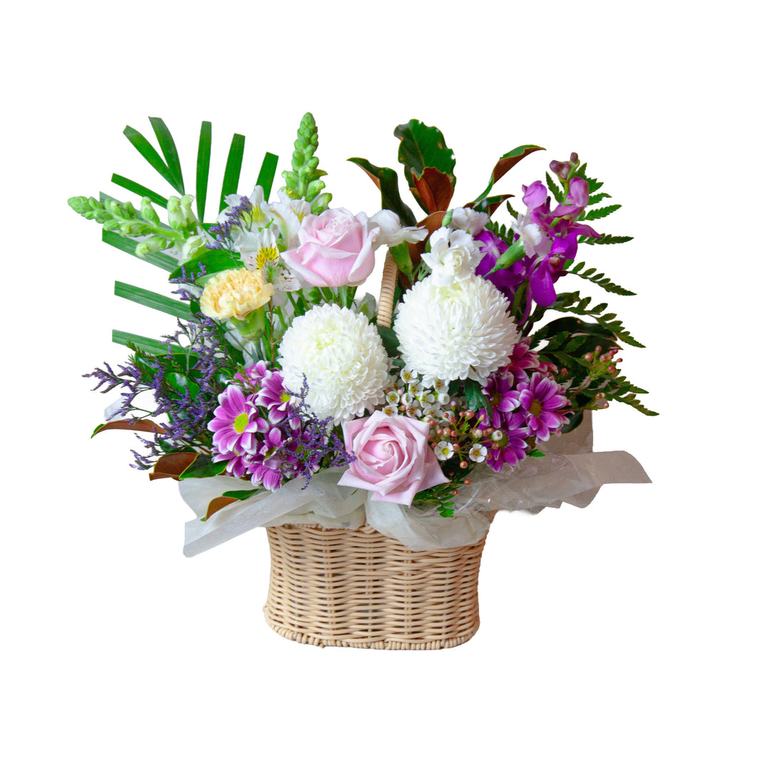 Sweet Blossom Basket featuring soft pink roses, white chrysanthemums and seasonal flowers in a keepsake basket.