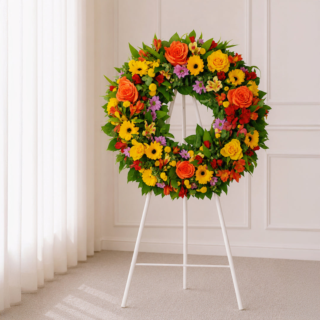 Amber Glow warm autumn sympathy wreath with orange roses, yellow gerberas and seasonal flowers by The Flori Shoppe Melbourne.