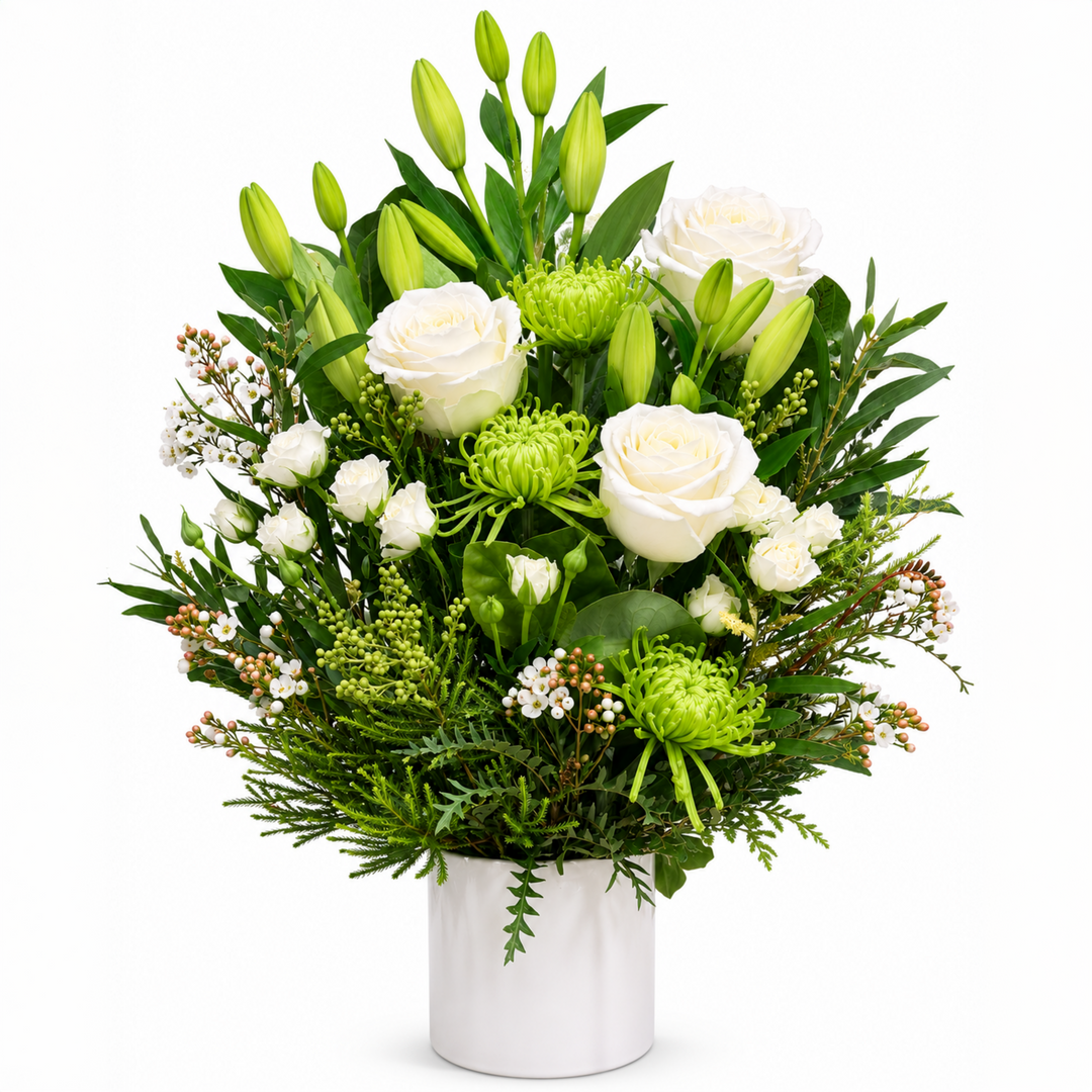 Whispering Pines white sympathy flower arrangement featuring premium white lilies, roses, chrysanthemums, alstroemeria and fresh seasonal foliage.