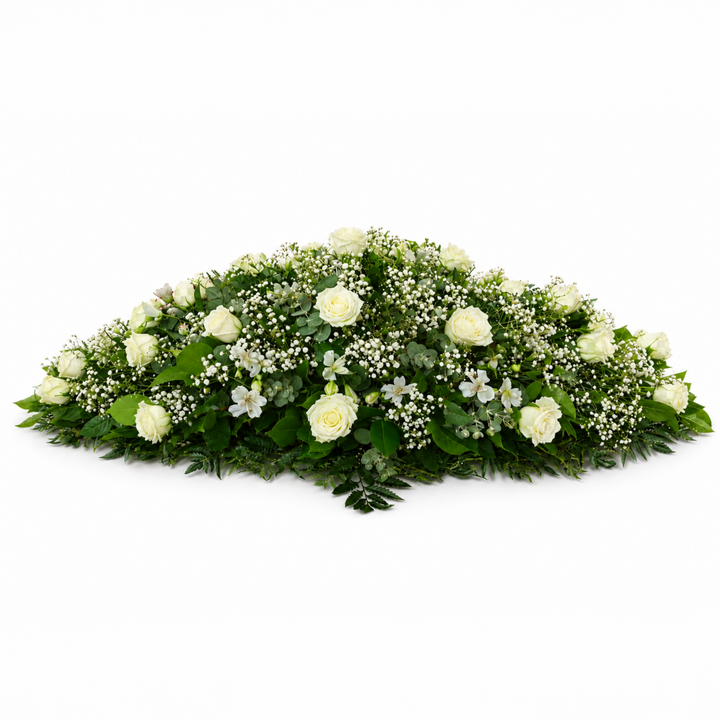 Classic White Casket Spray featuring white roses, baby's breath and fresh greenery arranged as an elegant funeral tribute.
