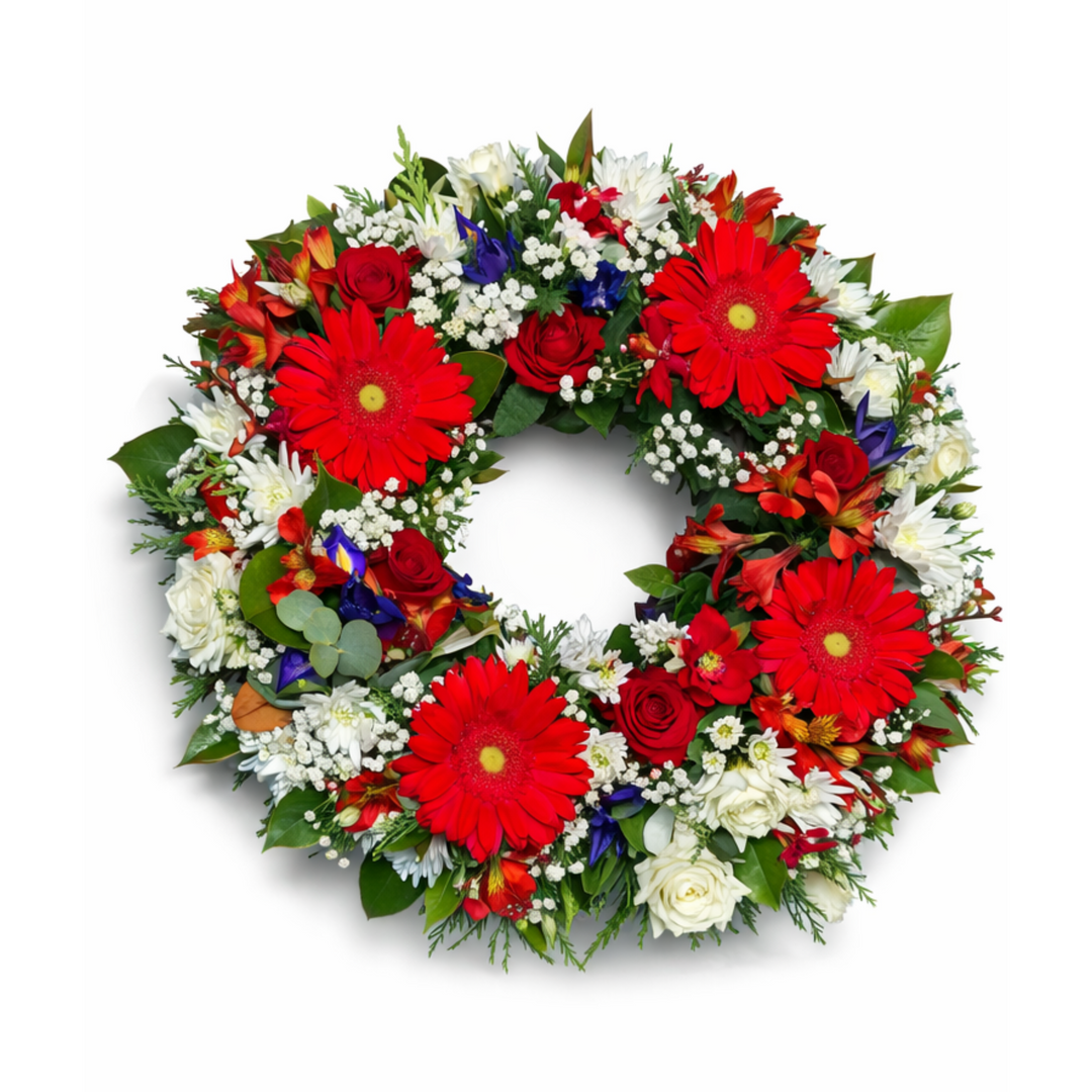 Lest We Forget remembrance wreath with red and white flowers on white background
