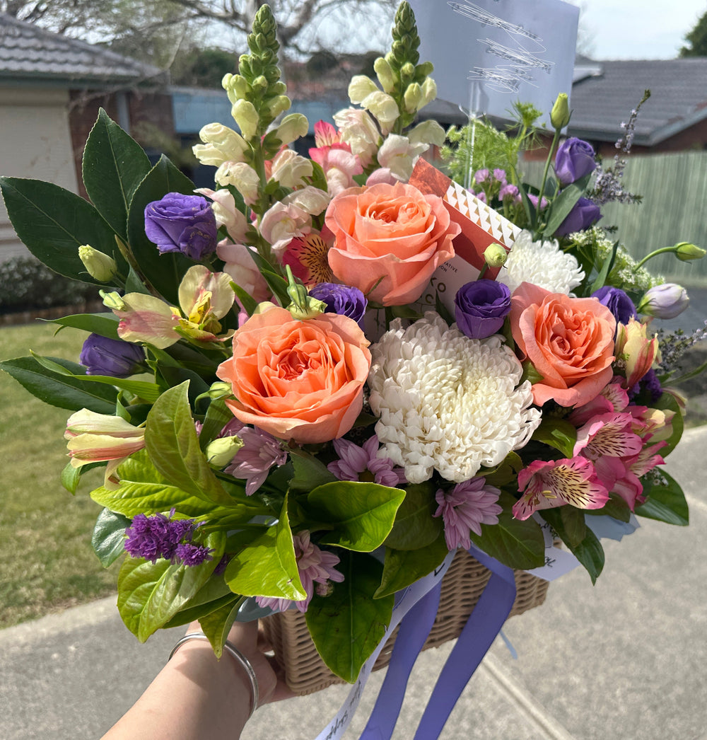 peach rose with white disbud ,snap dragon, beautiful basket arrangement by the flori shoppe