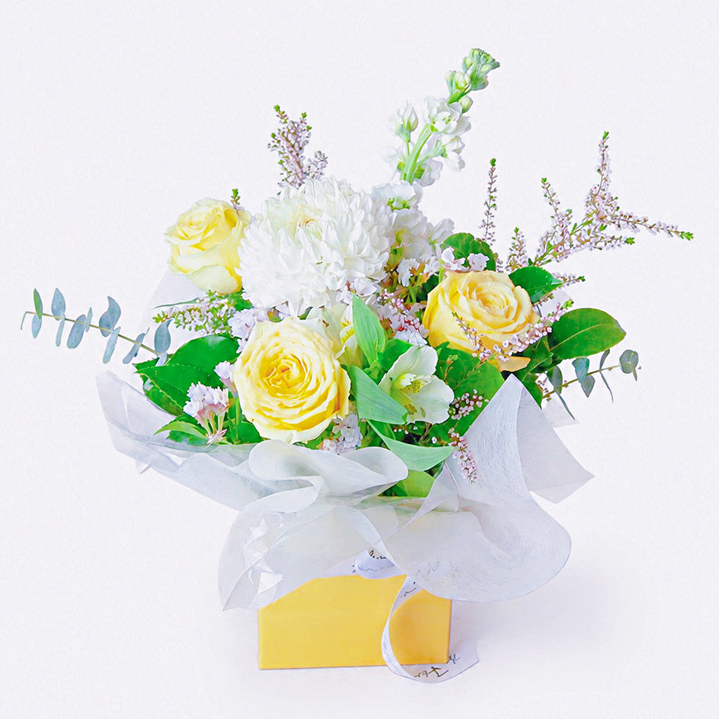 Buttercup soft yellow flower box arrangement featuring creamy yellow roses, seasonal chrysanthemums, and fresh greenery by The Flori Shoppe Melbourne.