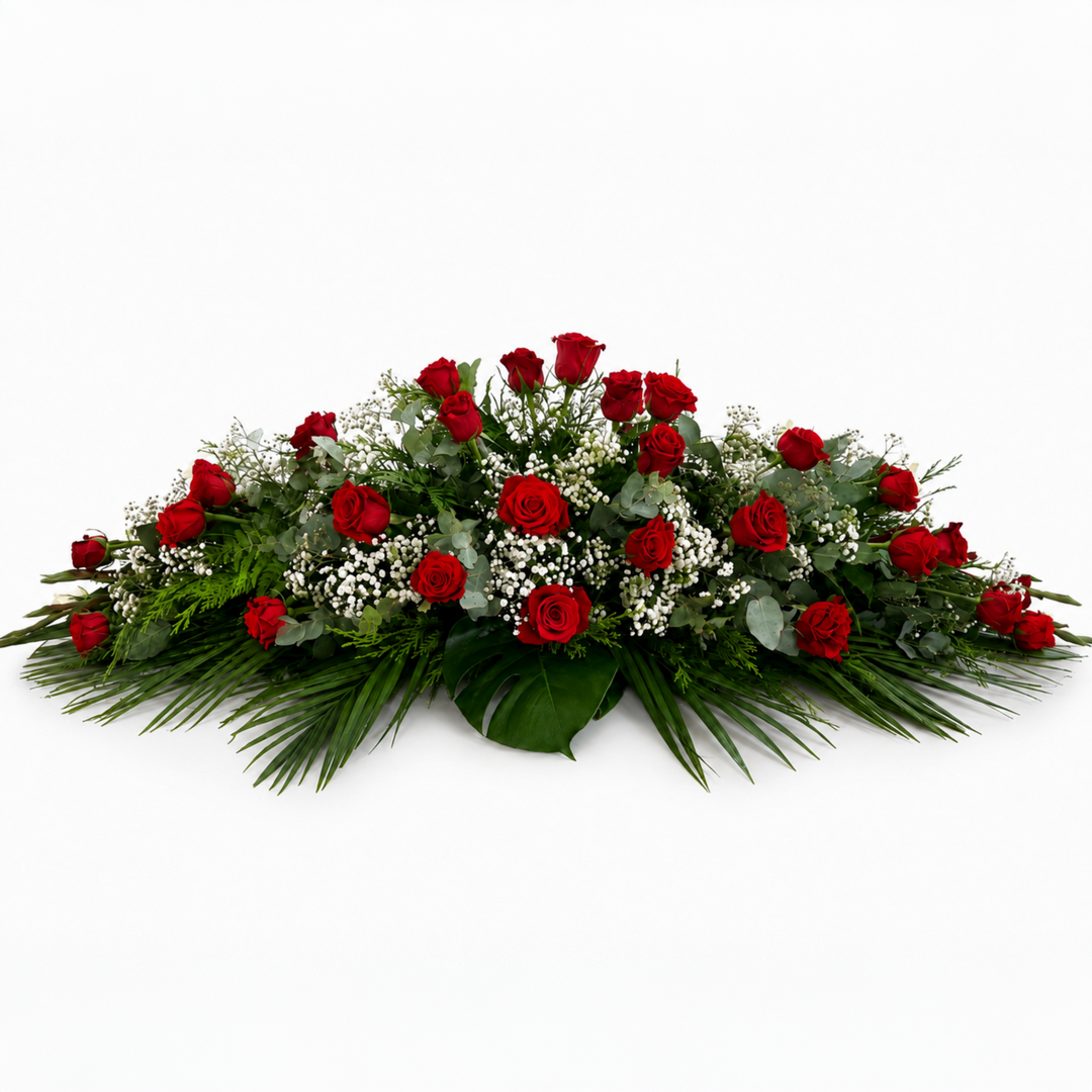 Classic funeral casket spray made entirely of premium red roses and lush foliage for Melbourne funeral services