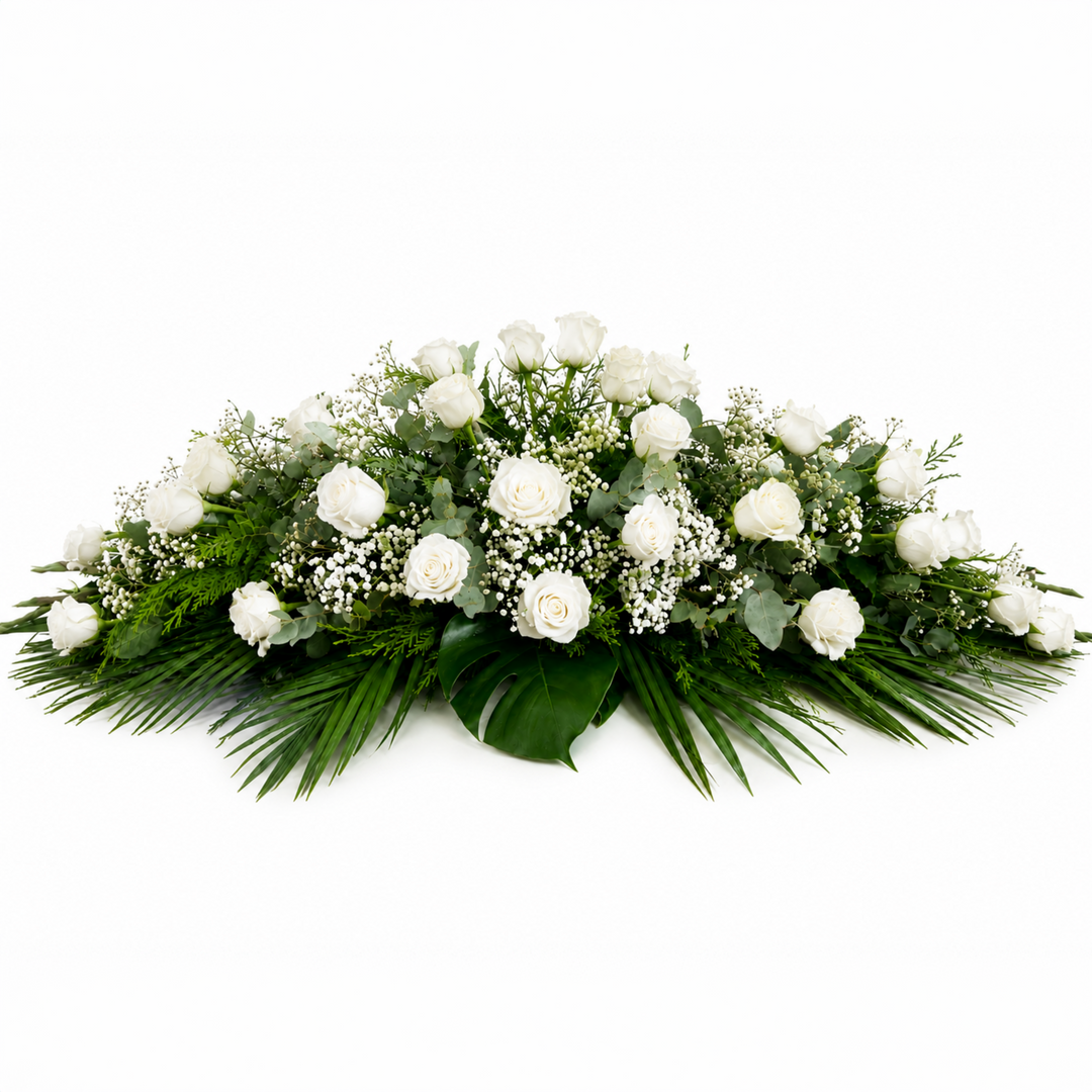 Order a classic all-white rose funeral casket spray in Melbourne. Handcrafted with premium white roses and lush greenery for a dignified funeral tribute.