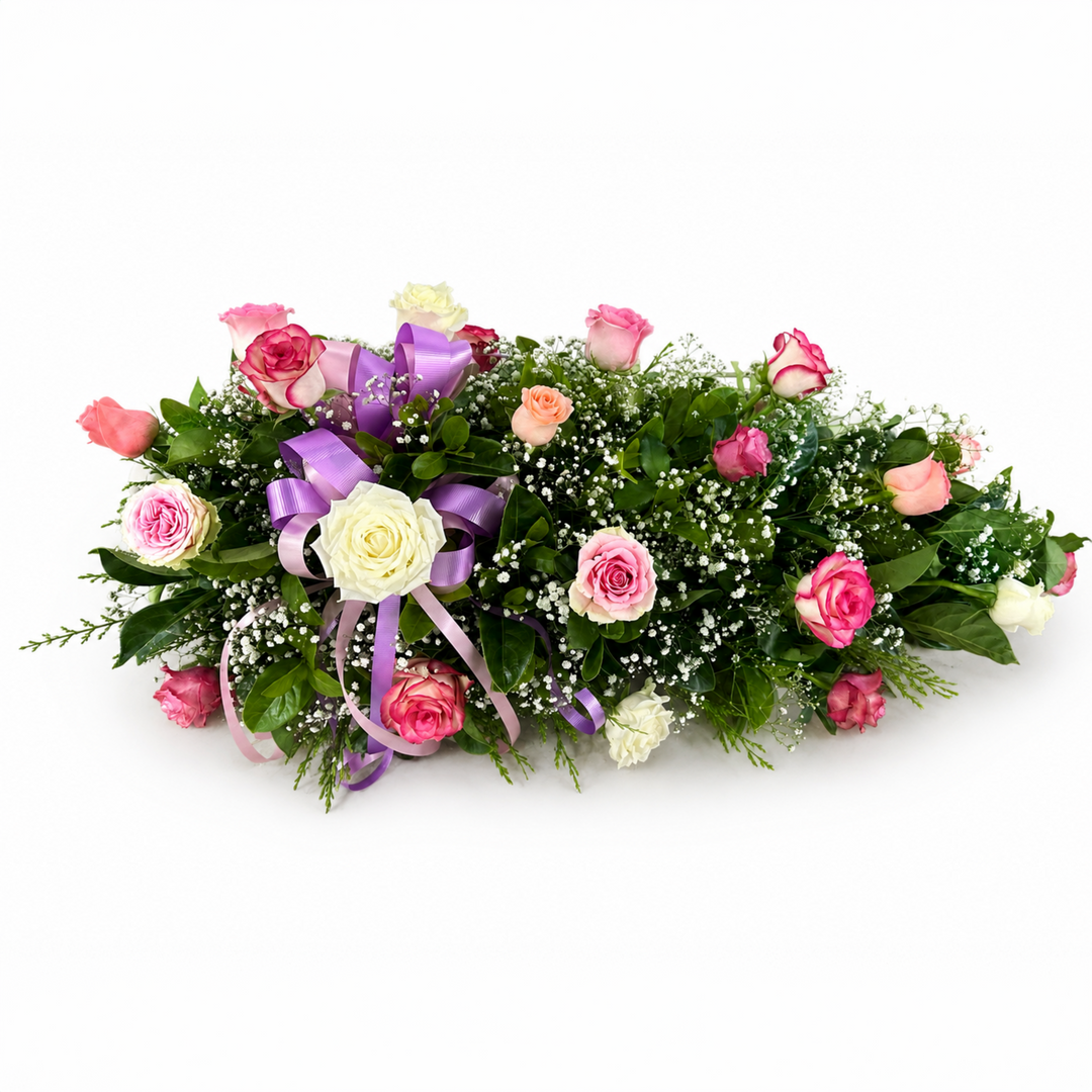 Loving Memories Pink Rose Single Ended Casket Spray with pink and white roses, baby's breath, green foliage, and purple ribbon in Melbourne
