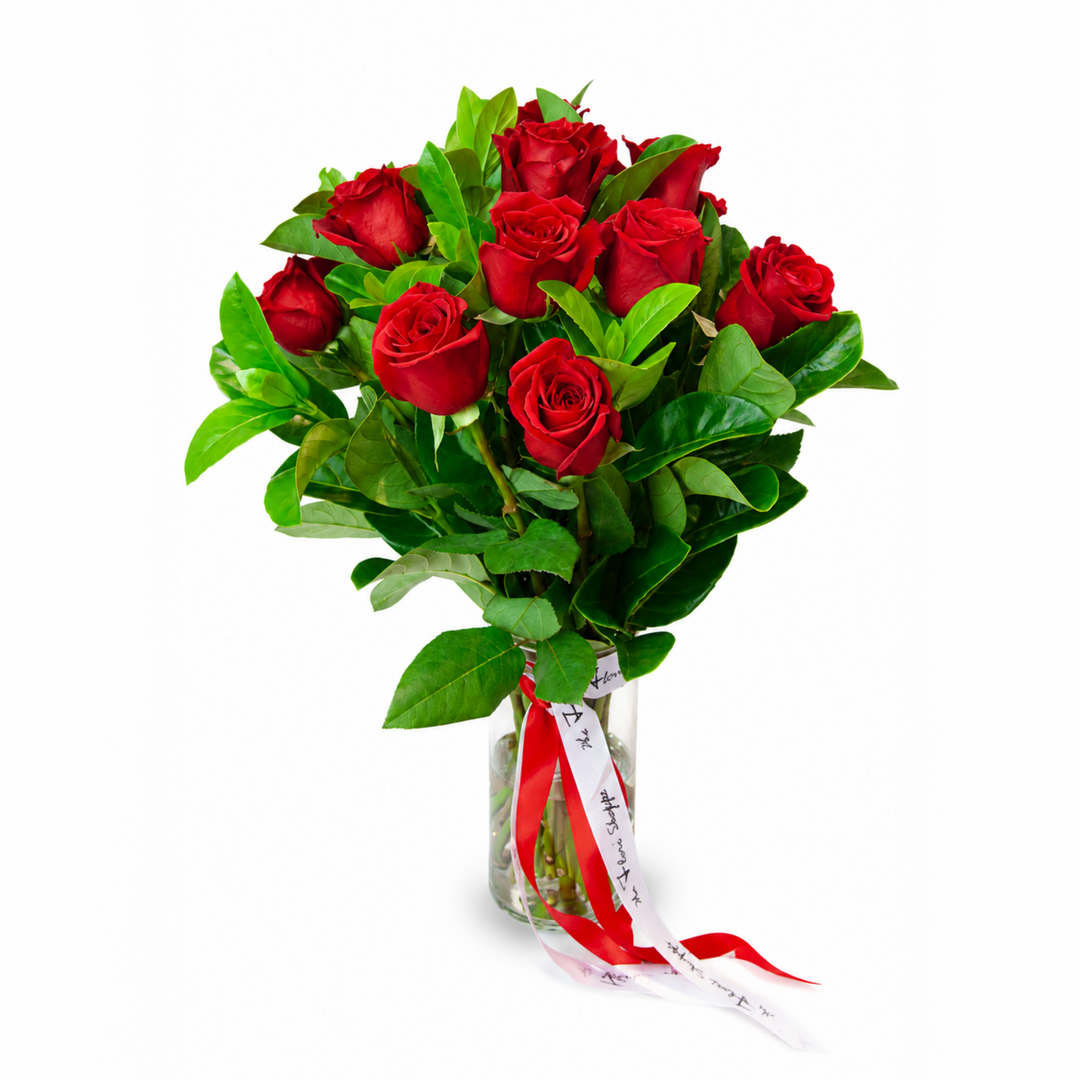 Red Roses Classic bouquet featuring premium fresh red roses in a clear crystal glass vase with red ribbon by The Flori Shoppe Melbourne.