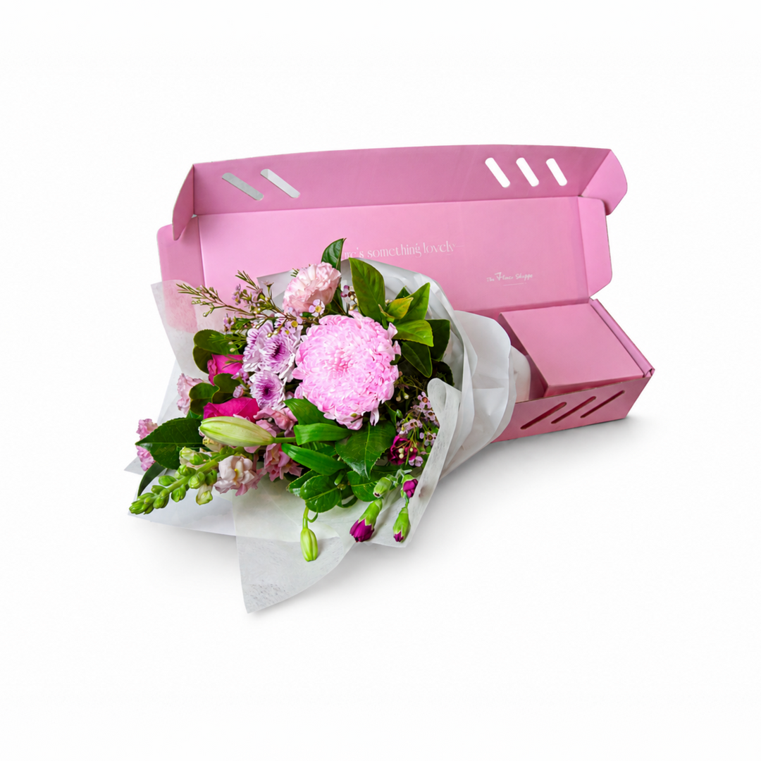 The Flori Box Hot Pinkbfeaturing a fresh seasonal petite bouquet nestled inside a signature pink gift box by The Flori Shoppe 