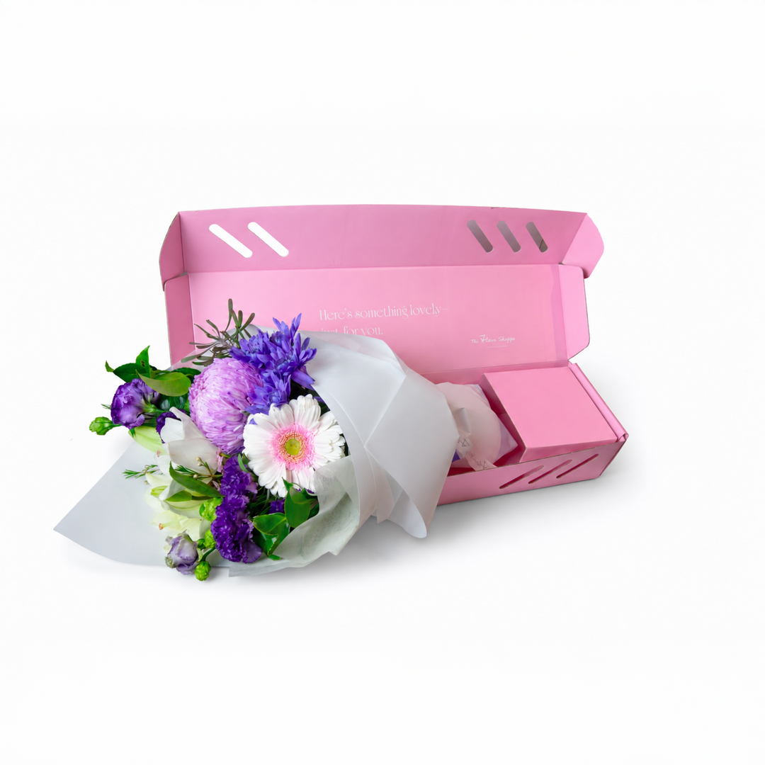 The Flori Box Lilac featuring a fresh seasonal petite bouquet nestled inside a signature pink gift box by The Flori Shoppe 