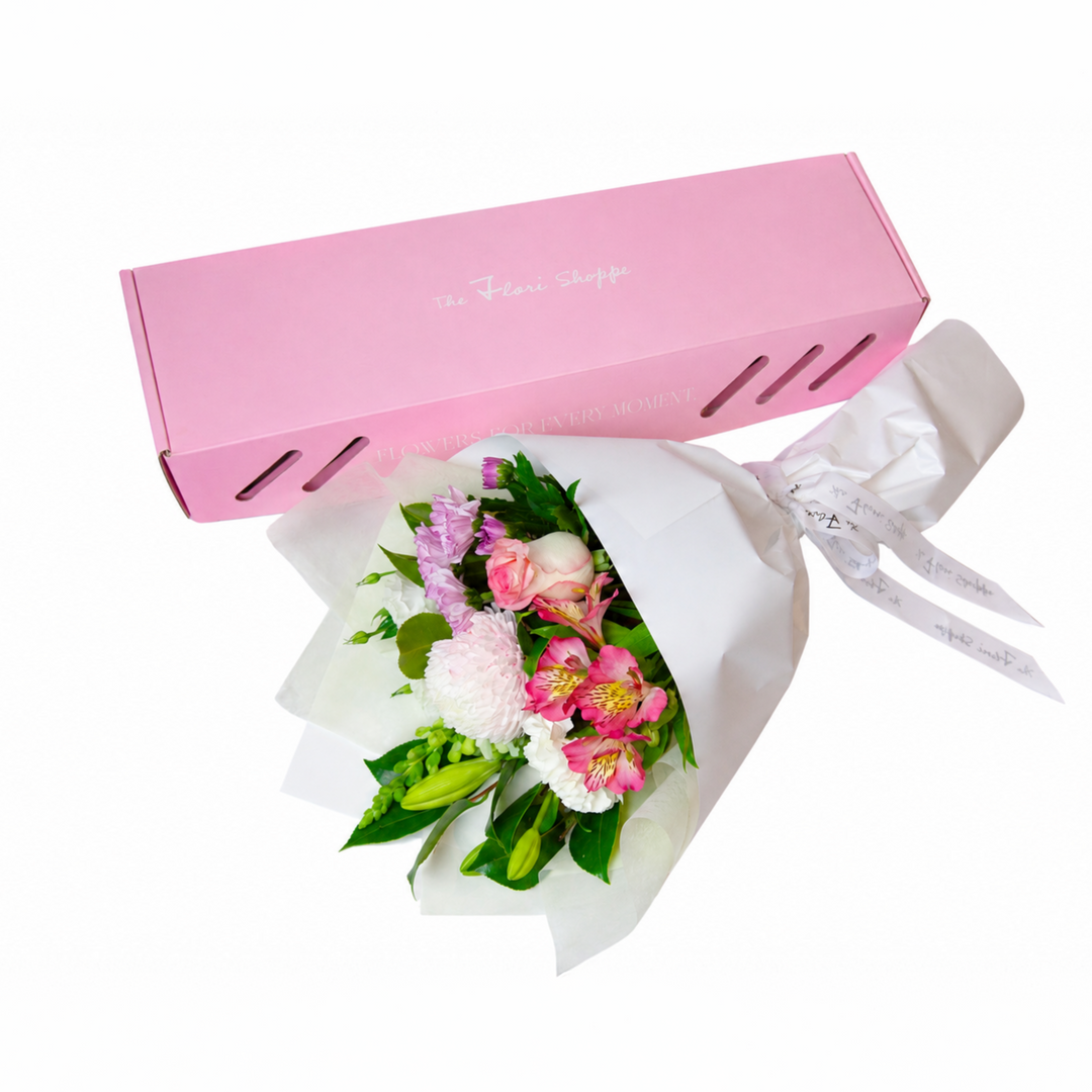 The Flori Box Blush featuring a fresh seasonal petite bouquet nestled inside a signature pink gift box by The Flori Shoppe.