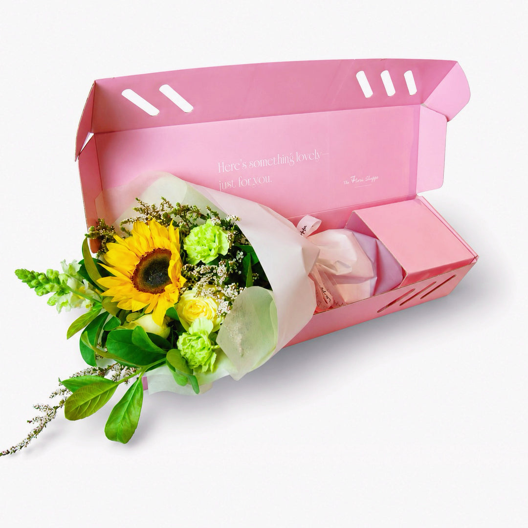 he Flori Box Hello Sunshine featuring a vibrant petite sunflower bouquet in fresh yellow, white and green tones, nestled inside a signature pink gift box by The Flori Shoppe Melbourne.