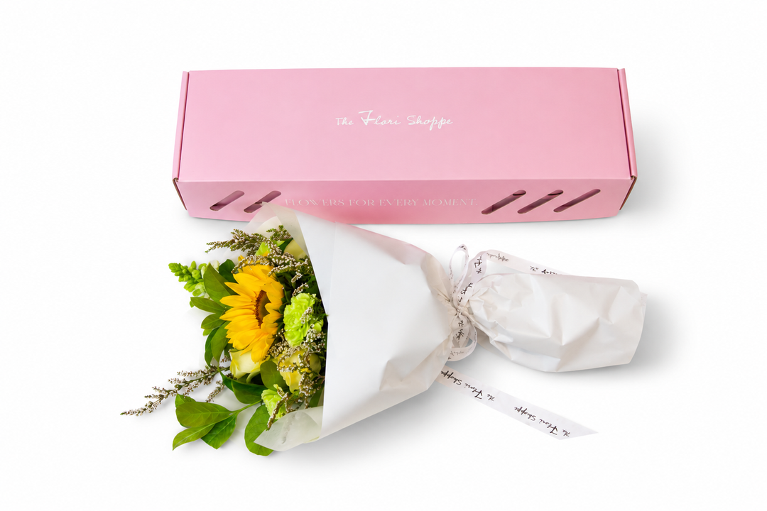 he Flori Box Hello Sunshine featuring a vibrant petite sunflower bouquet in fresh yellow, white and green tones, nestled inside a signature pink gift box by The Flori Shoppe Melbourne.
